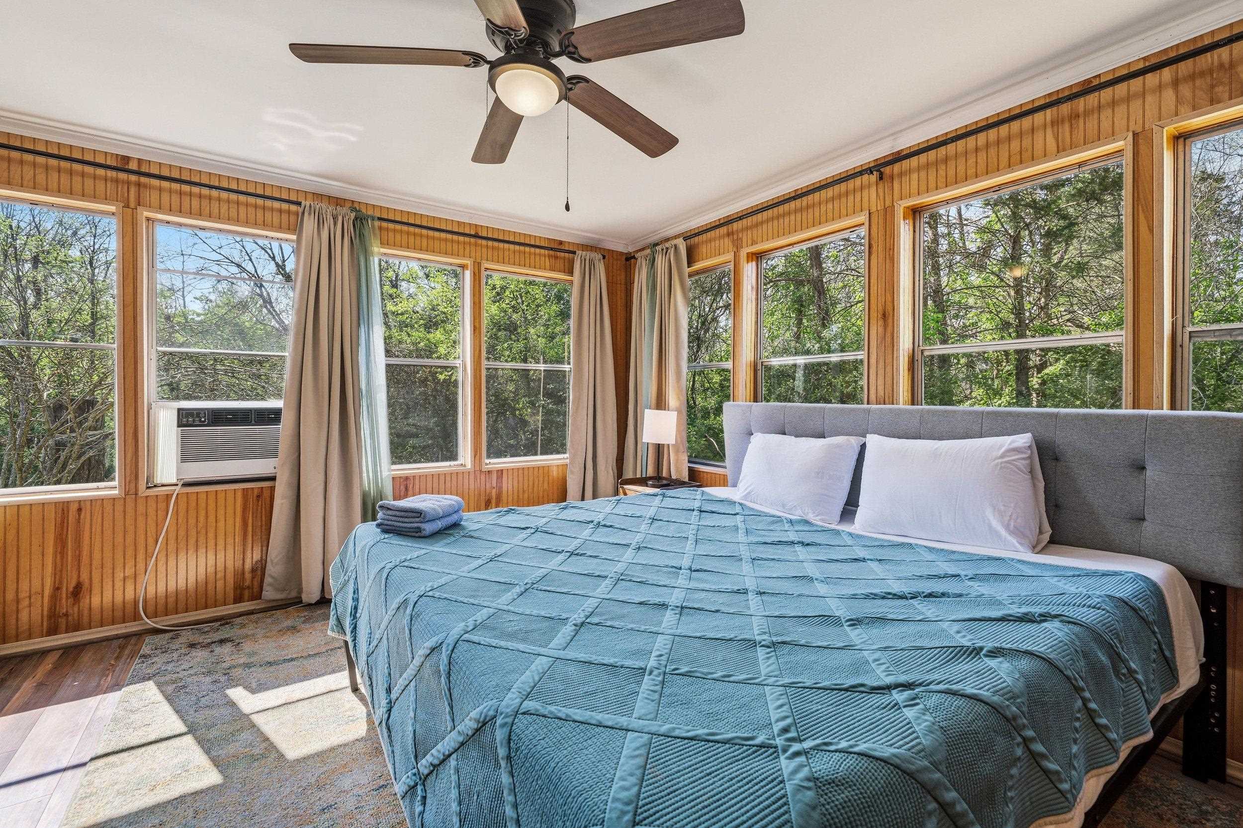 702 Richview Road Rileyville, VA 22650 - Photo 21 of 75 a bedroom with a large bed and a large window