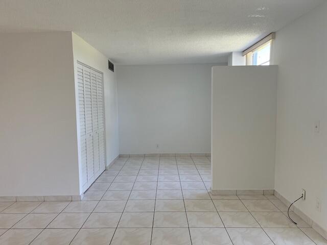5500 Northwest 2nd Avenue, Unit 123 Boca Raton, FL 33487 - Photo 15 of 48 an empty room with white walls and tiles