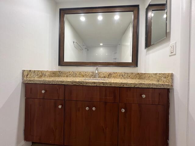 5500 Northwest 2nd Avenue, Unit 123 Boca Raton, FL 33487 - Photo 24 of 48 a bathroom with a granite countertop sink and mirror