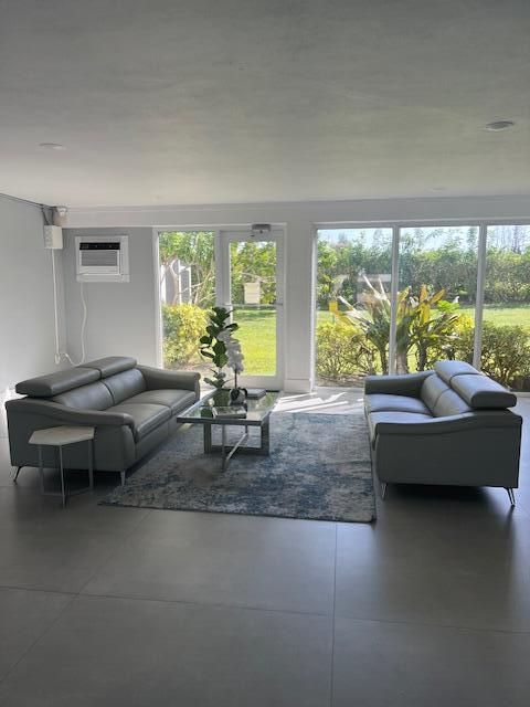5500 Northwest 2nd Avenue, Unit 123 Boca Raton, FL 33487 - Photo 39 of 48 a living room with furniture and a large window