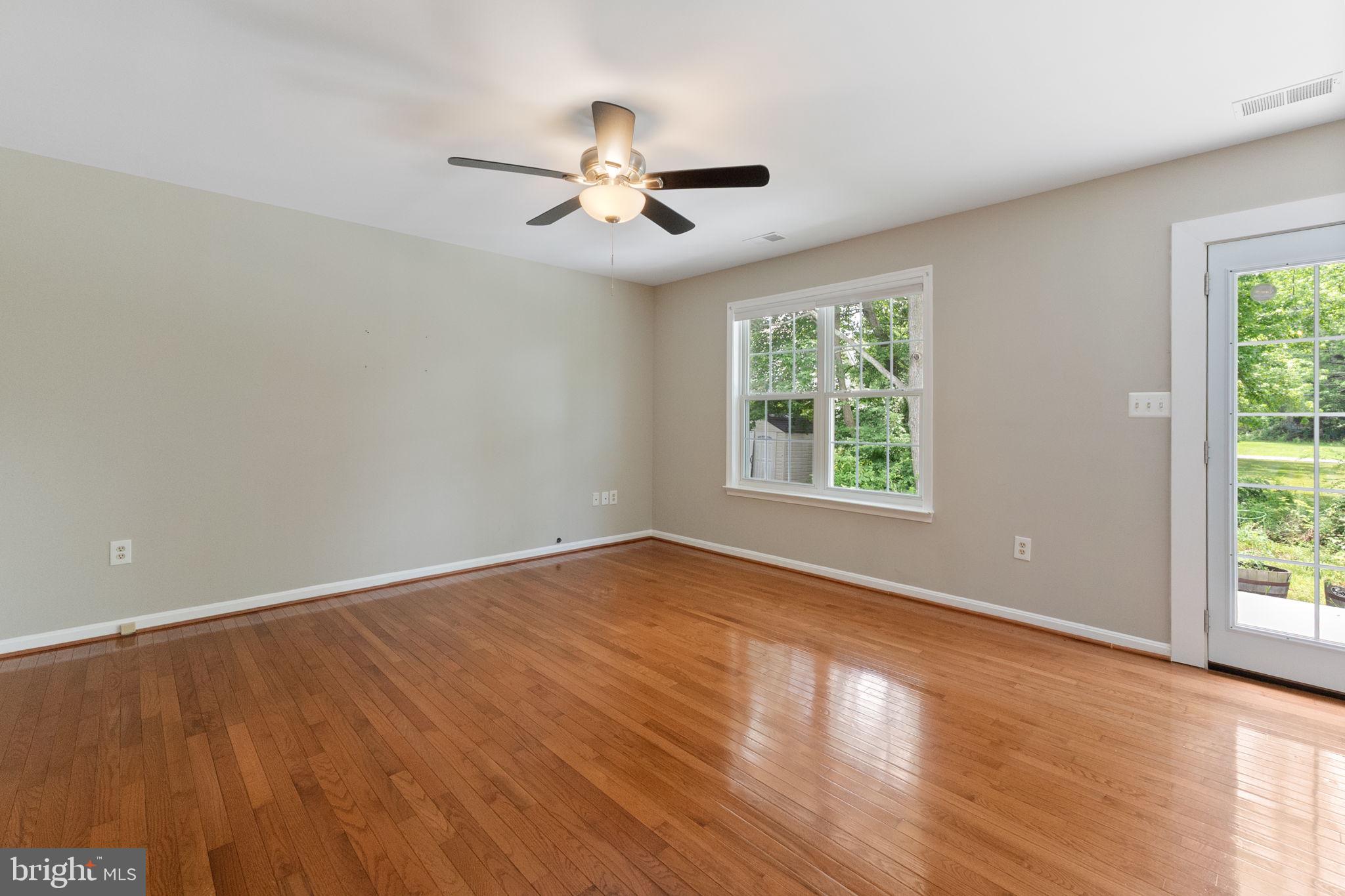 1527 Lincoln Road Shady Side, MD 20764 - Photo 6 of 30 a view of an empty room with wooden floor and a window
