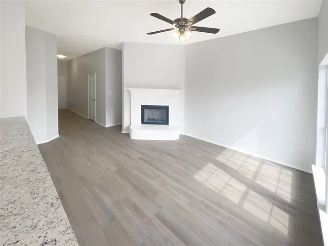 wooden floor in an empty room with a fireplace