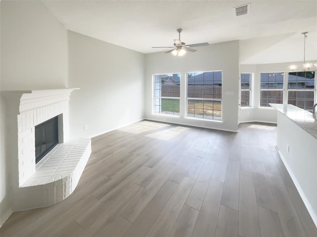 3724 Tulip Tree Drive Fort Worth, TX 76137 - Photo 12 of 30 a view of an empty room with wooden floor and a window