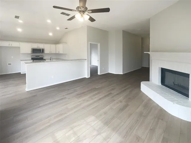 a view of a kitchen with a sink and a fireplace