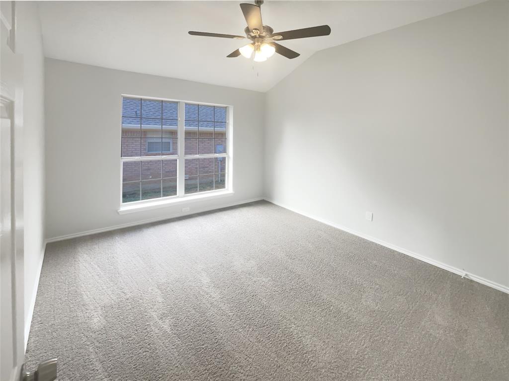 3724 Tulip Tree Drive Fort Worth, TX 76137 - Photo 19 of 30 an empty room with windows and fan