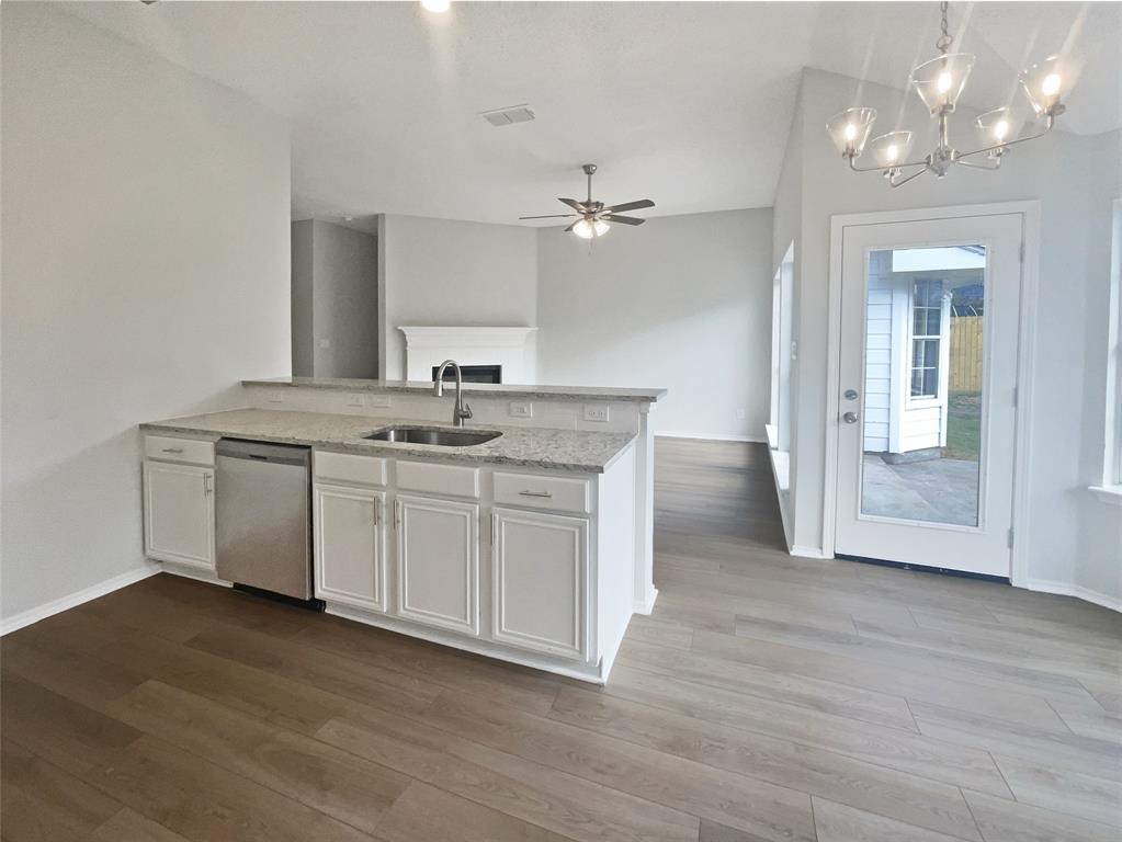 3724 Tulip Tree Drive Fort Worth, TX 76137 - Photo 7 of 30 a kitchen with a sink cabinets and wooden floor