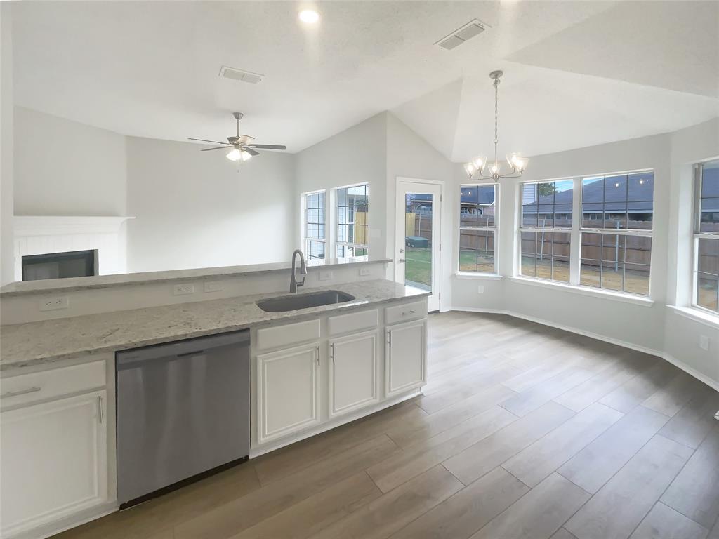 3724 Tulip Tree Drive Fort Worth, TX 76137 - Photo 8 of 30 a large kitchen with kitchen island a counter space a sink and a chandelier