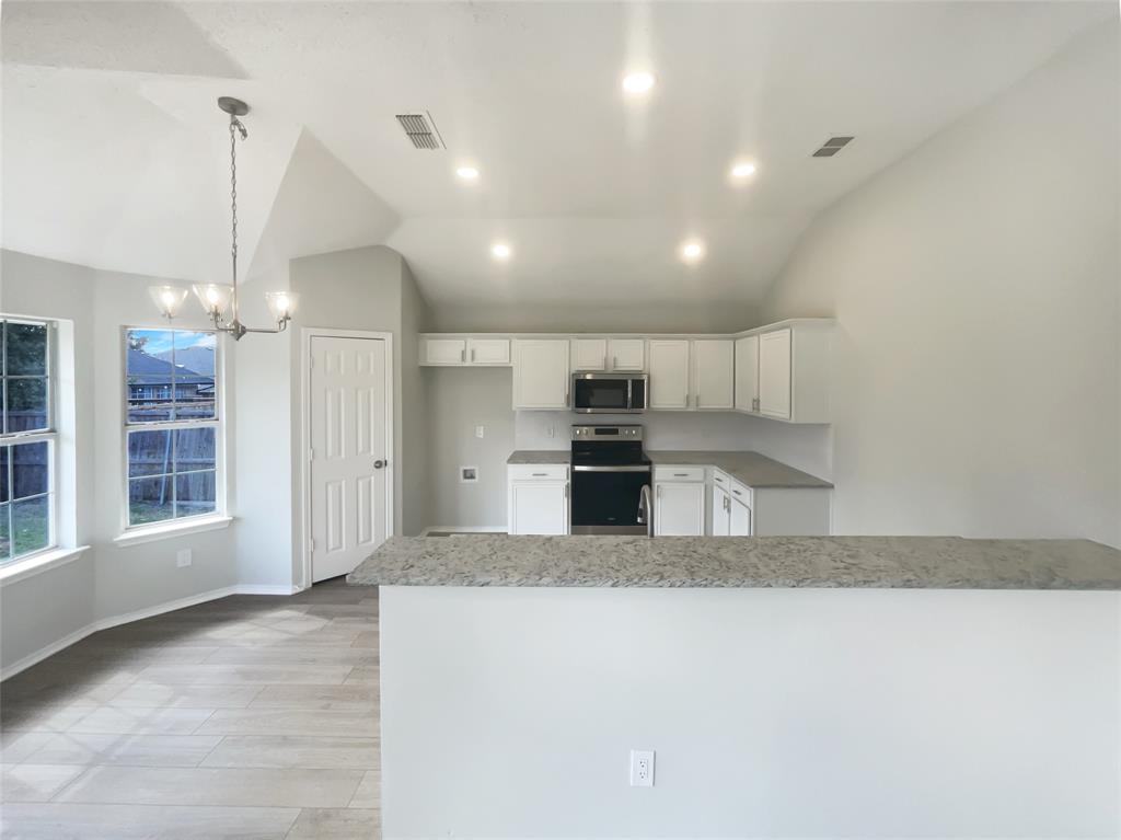3724 Tulip Tree Drive Fort Worth, TX 76137 - Photo 9 of 30 a large kitchen with kitchen island granite countertop a large counter top stainless steel appliances and cabinets