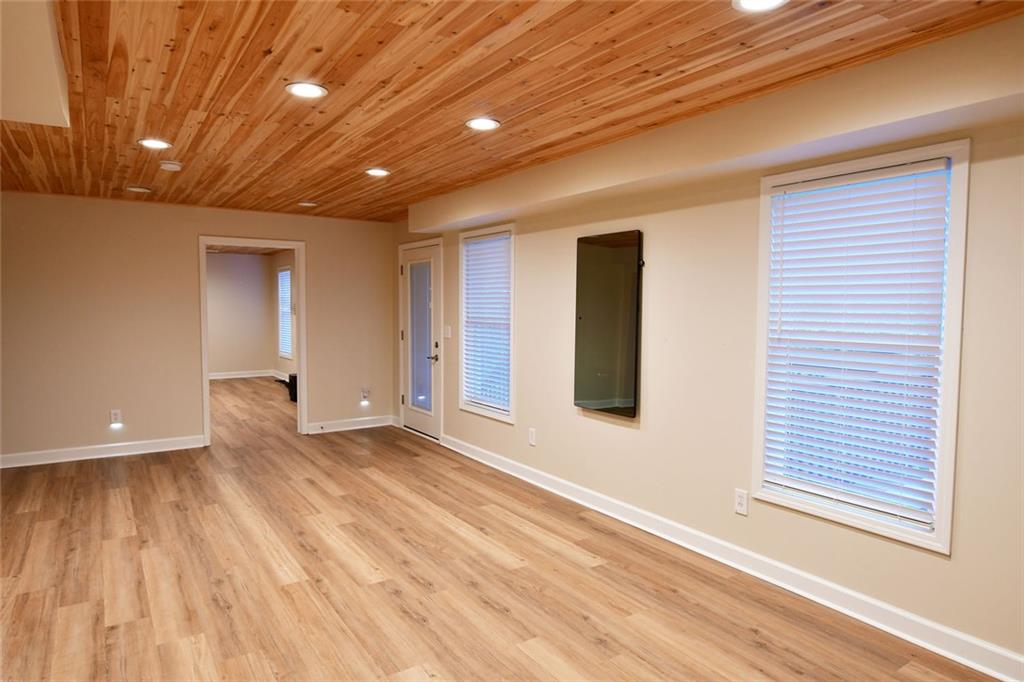 1767 Honey Tree Place Hoschton, GA 30548 - Photo 21 of 54 a view of an empty room with wooden floor and a window