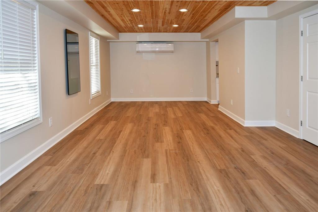 1767 Honey Tree Place Hoschton, GA 30548 - Photo 22 of 54 a view of an empty room with wooden floor and a window