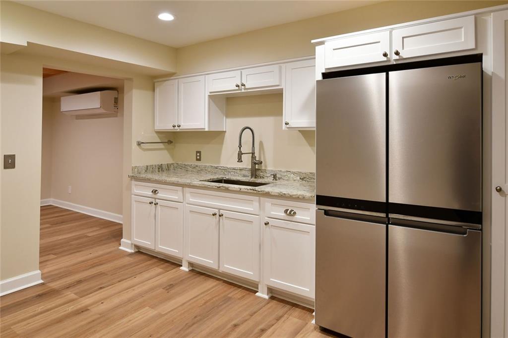 1767 Honey Tree Place Hoschton, GA 30548 - Photo 23 of 54 a kitchen with a refrigerator and a sink
