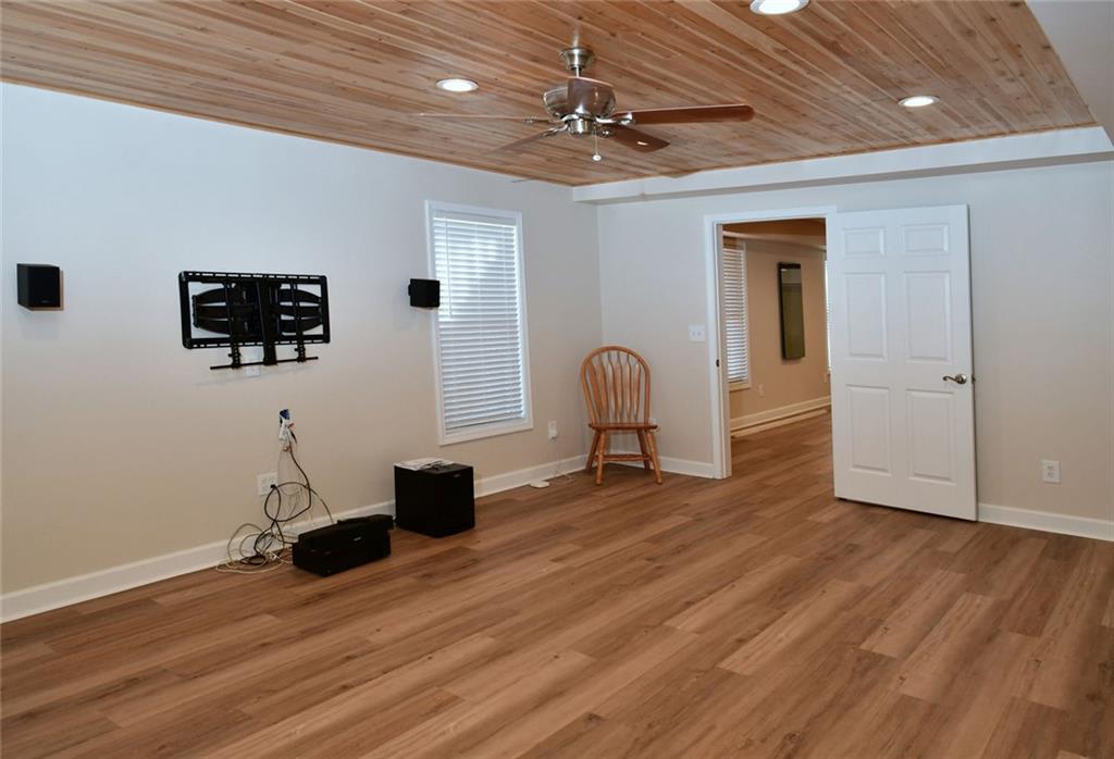 1767 Honey Tree Place Hoschton, GA 30548 - Photo 28 of 54 a view of a livingroom with wooden floor and a ceiling fan