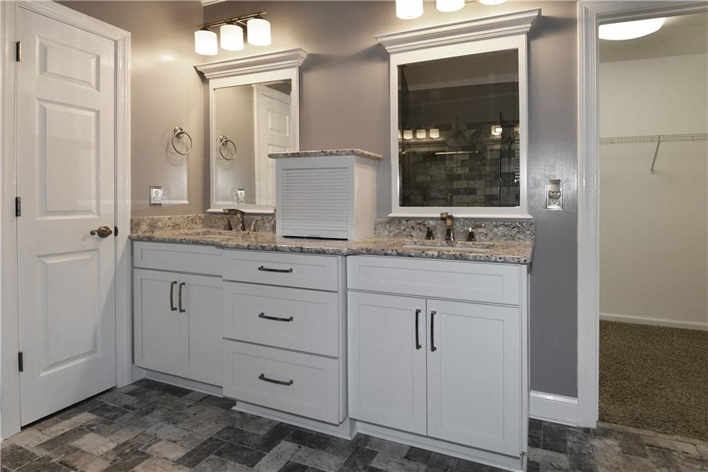 1767 Honey Tree Place Hoschton, GA 30548 - Photo 38 of 54 a bathroom with a granite countertop sink and a mirror
