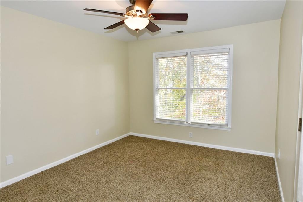 1767 Honey Tree Place Hoschton, GA 30548 - Photo 39 of 54 an empty room with a window and a fan