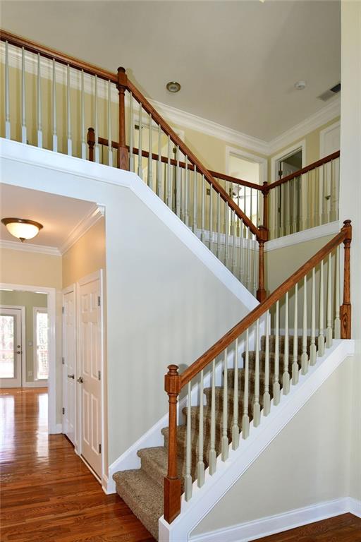 1767 Honey Tree Place Hoschton, GA 30548 - Photo 4 of 54 a view of staircase with lots of wooden floor and stairs