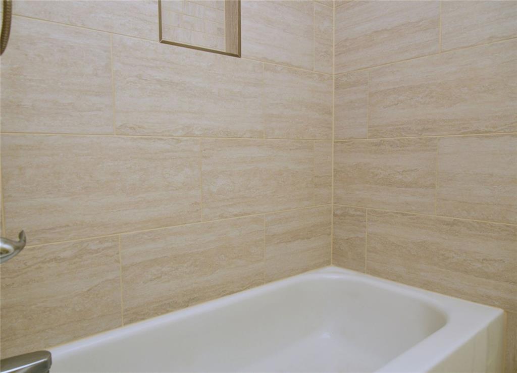 1767 Honey Tree Place Hoschton, GA 30548 - Photo 45 of 54 a bathroom with a bathtub