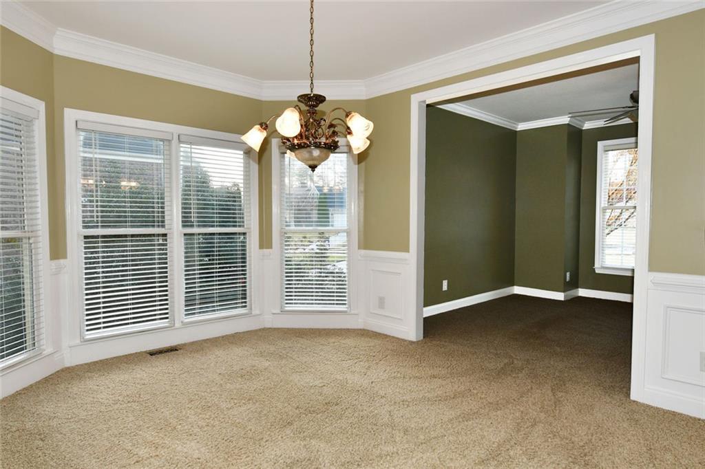 1767 Honey Tree Place Hoschton, GA 30548 - Photo 8 of 54 a view of a livingroom with a chandelier fan and windows