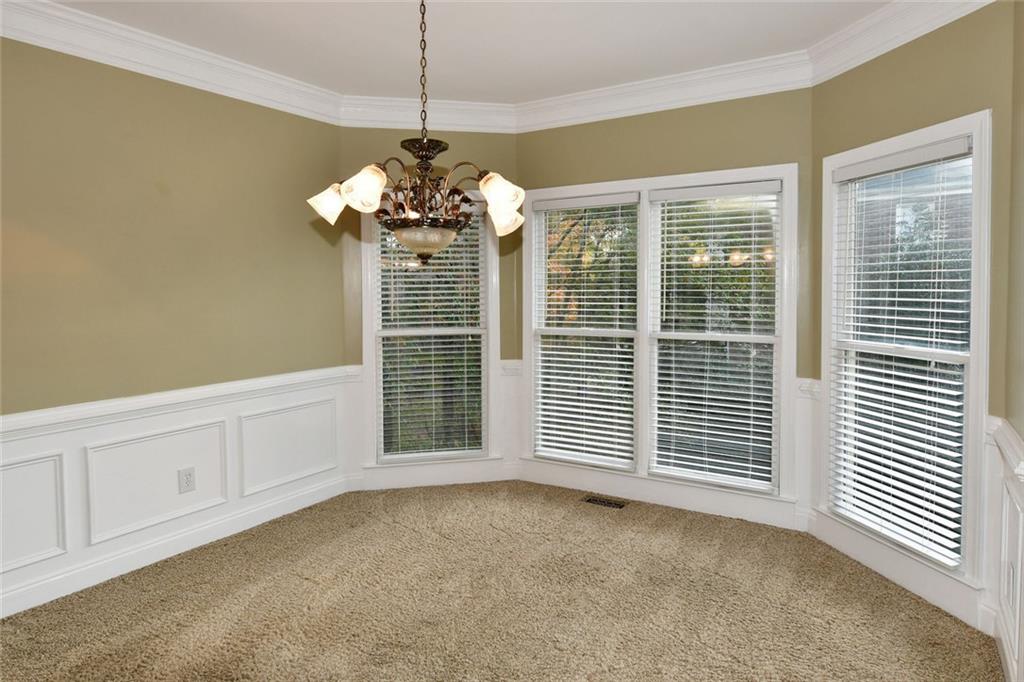1767 Honey Tree Place Hoschton, GA 30548 - Photo 9 of 54 a view of a livingroom with a chandelier fan and windows