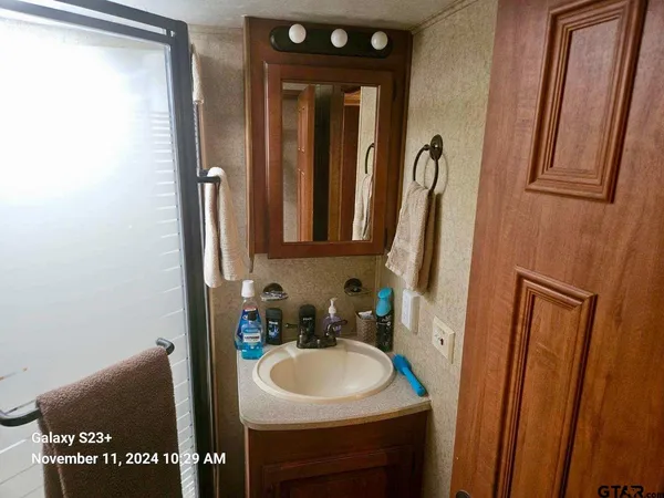 a bathroom with a sink a toilet and a mirror