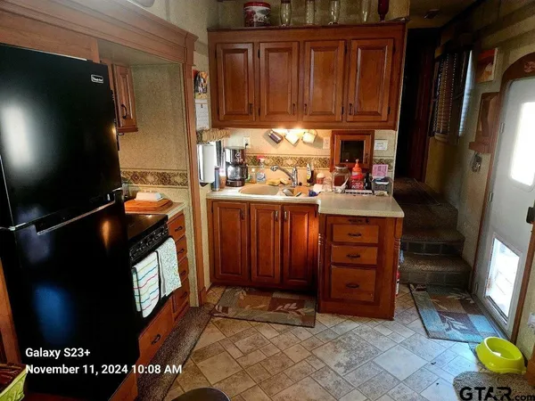 a kitchen with granite countertop a stove top oven a sink and cabinets