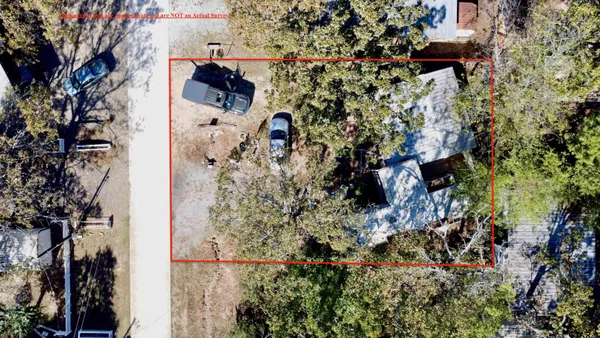 a room with lots of tables a large window and chairs