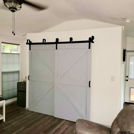 a view of a room with wooden floor and fan