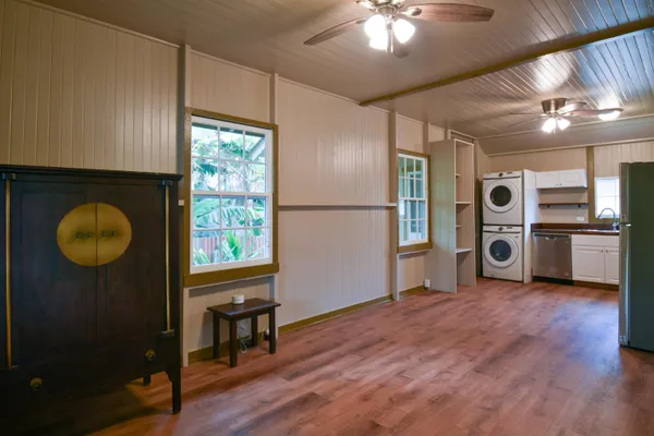 a kitchen with stainless steel appliances granite countertop a refrigerator a stove and a wooden floors