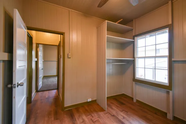 an empty room with wooden floor and a window