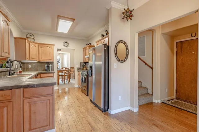 a view of a kitchen with a refrigerator cabinets and a wooden floor