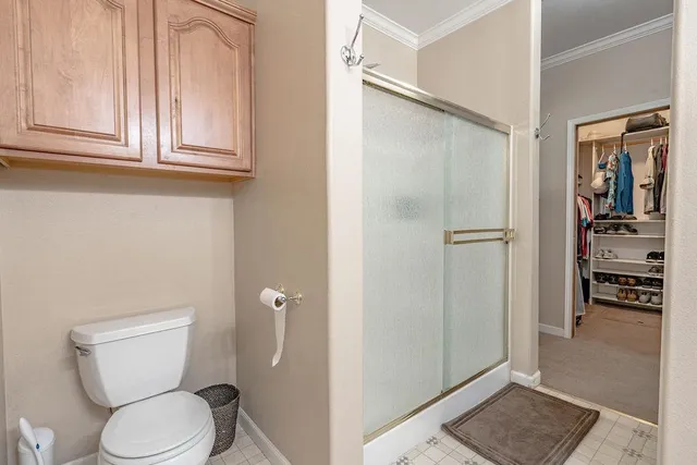 a bathroom with a toilet and a shower