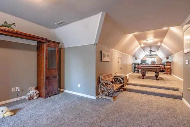 an empty room with closet and mirrors