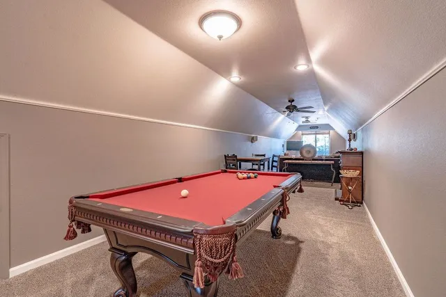 a front view of a house with a yard and potted plants