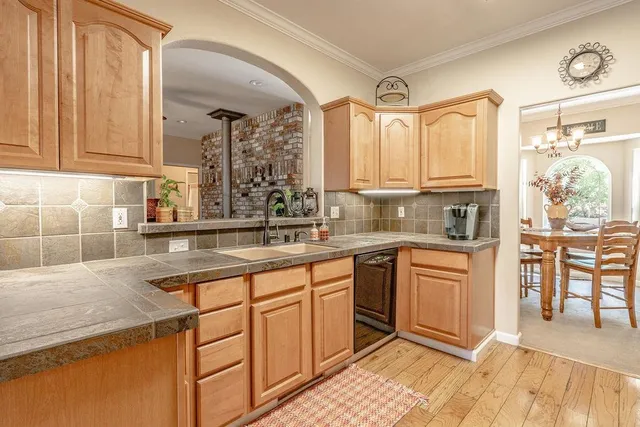a kitchen with stainless steel appliances granite countertop a sink and cabinets