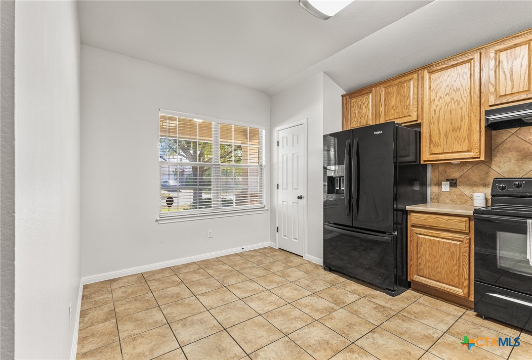7733 Little Deer Trail Georgetown, TX 78628 - Photo 11 of 36 a kitchen with stainless steel appliances a refrigerator and a stove top oven