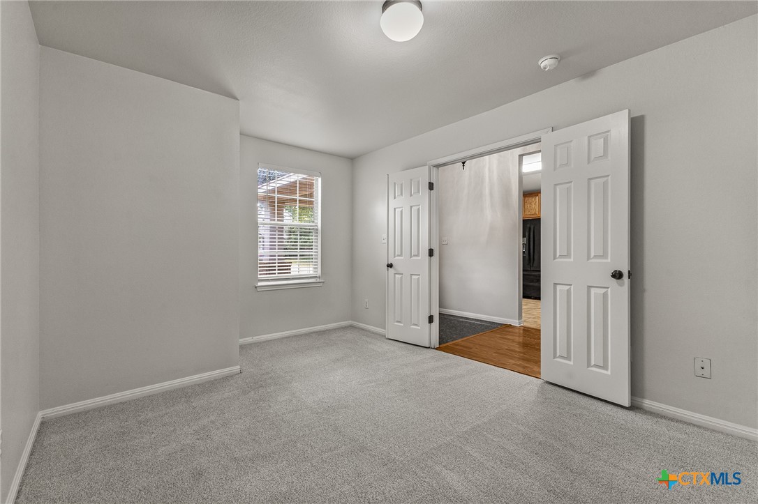 7733 Little Deer Trail Georgetown, TX 78628 - Photo 13 of 36 an empty room with windows and closet