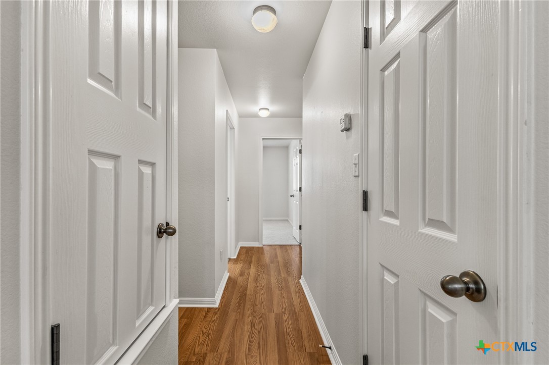 7733 Little Deer Trail Georgetown, TX 78628 - Photo 25 of 36 a view of a hallway with wooden floor and closet area