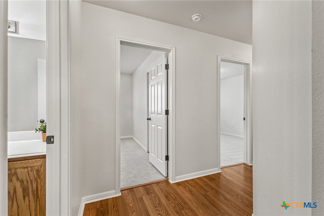 7733 Little Deer Trail Georgetown, TX 78628 - Photo 27 of 36 a view of a hallway with wooden floor and entryway