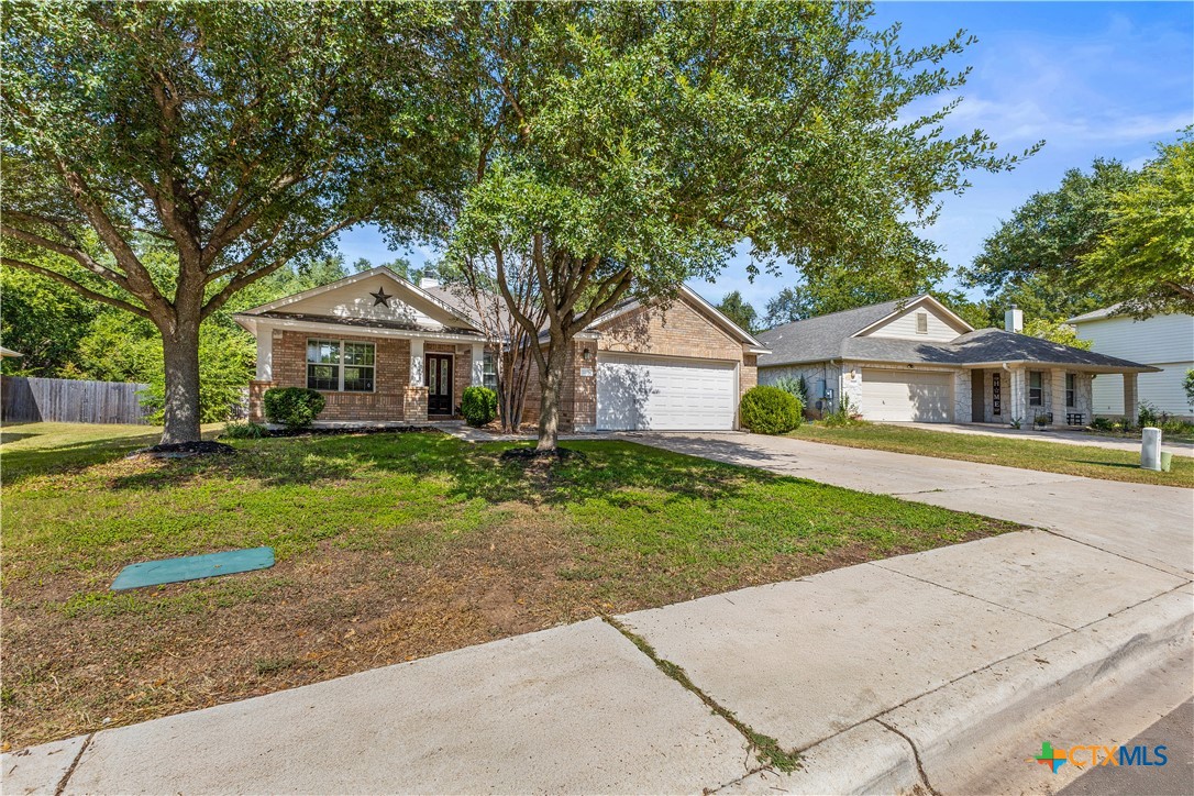 7733 Little Deer Trail Georgetown, TX 78628 - Photo 3 of 36 a front view of a house with a yard