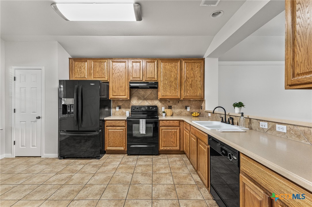 7733 Little Deer Trail Georgetown, TX 78628 - Photo 8 of 36 a kitchen with a refrigerator sink and stove