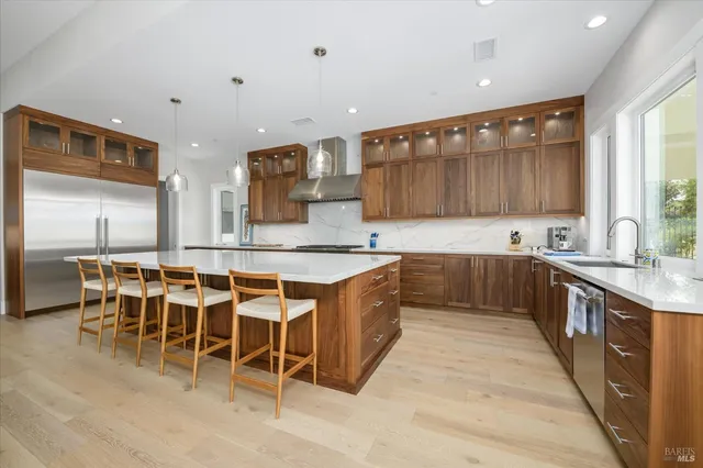 a large kitchen with a table and chairs in it