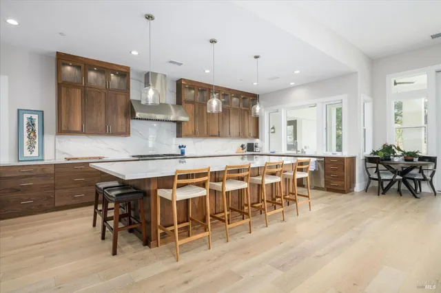 a view of a kitchen with cabinets and wooden floor