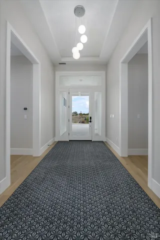 a view of hallway with wooden floor