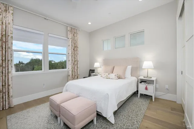 a bathroom with a toilet sink vanity granite and shower