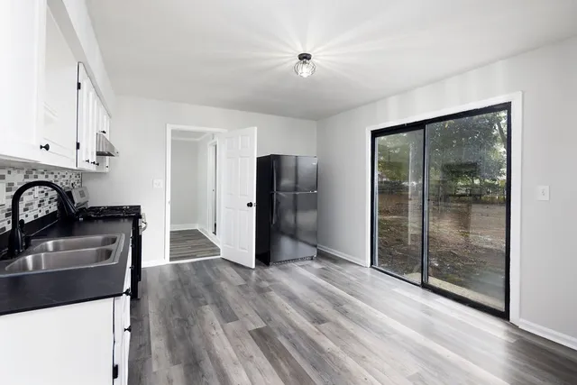 wooden floor in an empty room with a window
