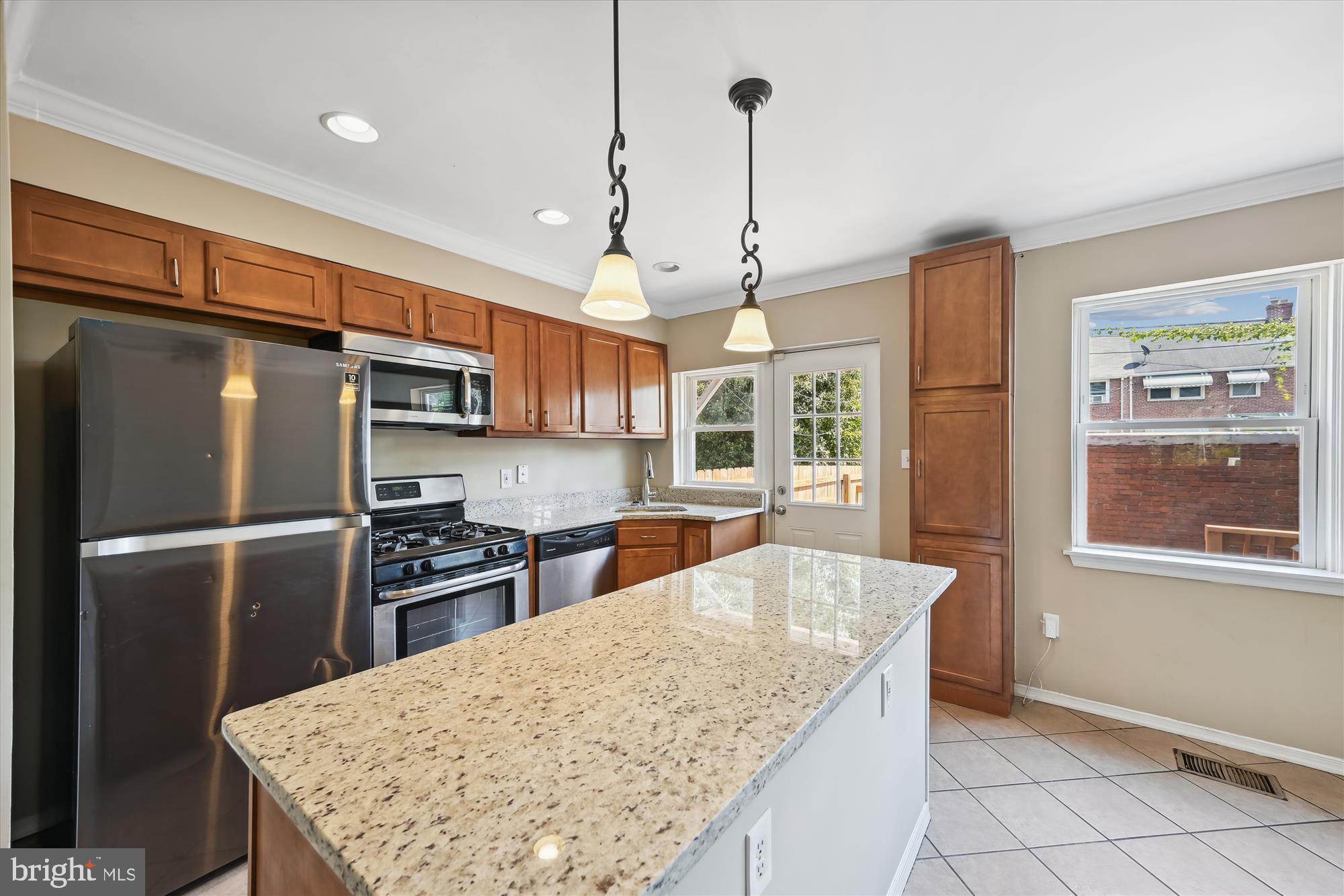 4545 Marble Hall Road Baltimore, MD 21239 - Photo 6 of 36 a kitchen with stainless steel appliances granite countertop a refrigerator a sink a stove and a center island