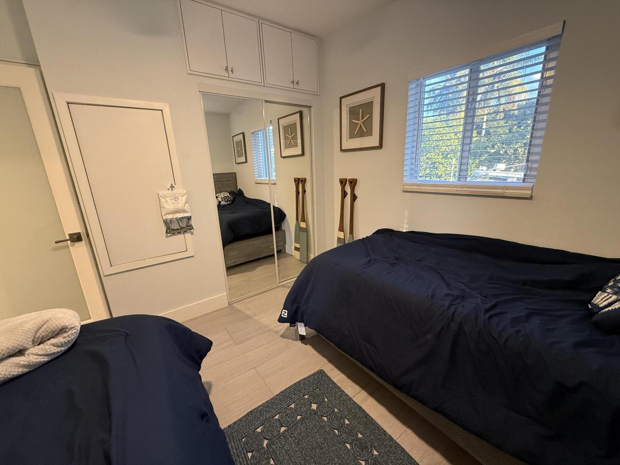 116 Long Ben Drive Key Largo, FL 33037 - Photo 14 of 26 a bedroom with a bed window and dresser