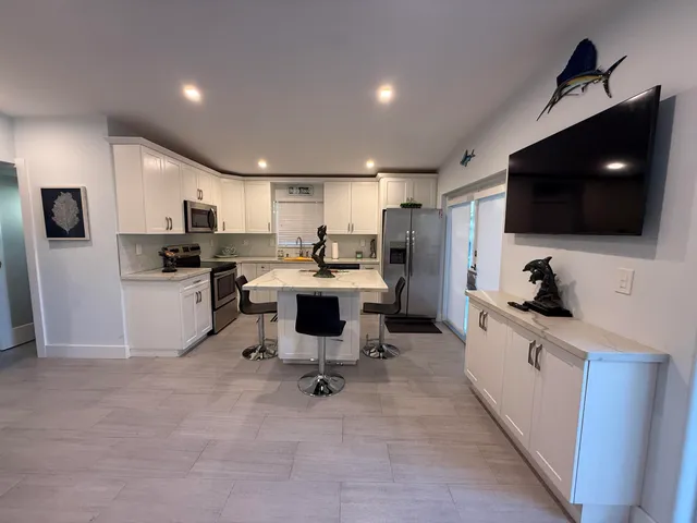 a kitchen with a sink a stove a refrigerator and cabinets