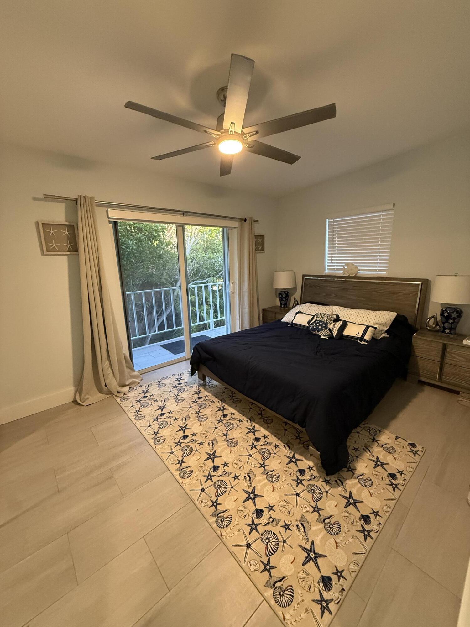 116 Long Ben Drive Key Largo, FL 33037 - Photo 10 of 26 a bedroom with a bed and a window