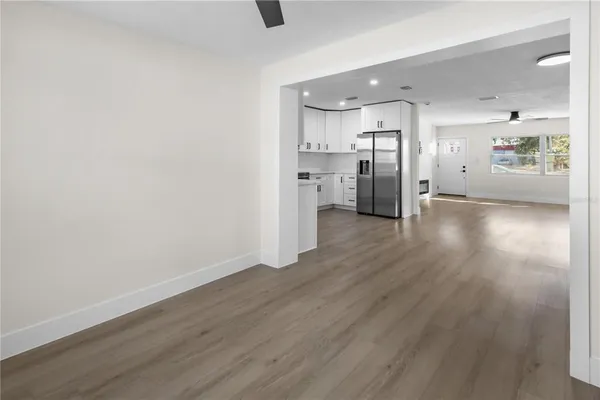 a view of a kitchen with a sink and wooden floor
