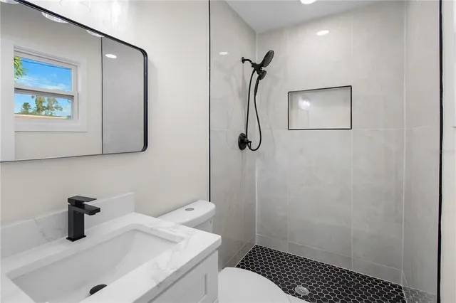 a bathroom with a sink toilet and vanity